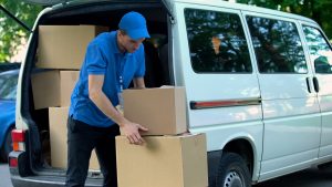 Join the Rapidgo Inc Delivery Network Rapidgo driver unloading parcels from a van.